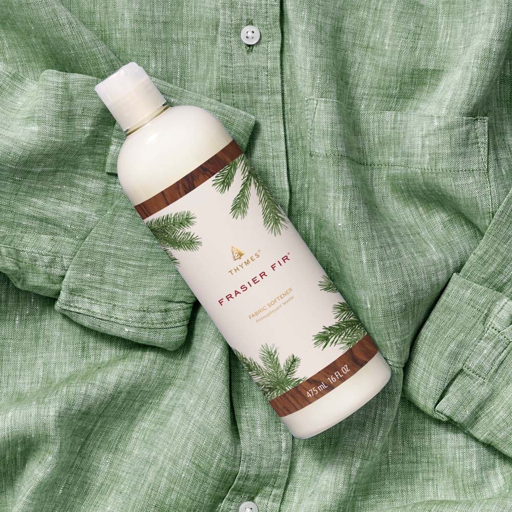 Thymes Frasier Fir Fabric Softener laundry care flat lay on green shirt image number 2